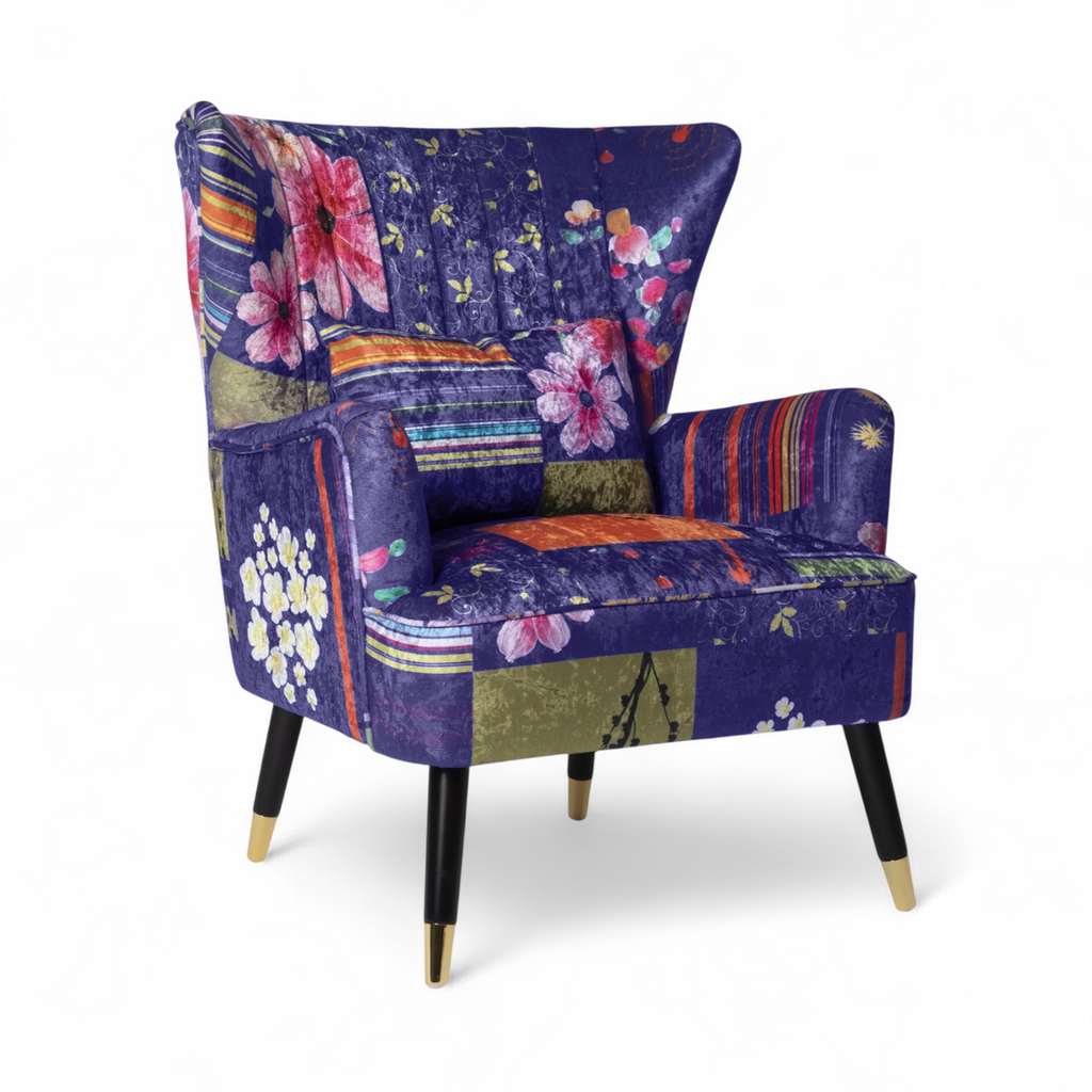 Colorful armchair with floral and patchwork design on a white background